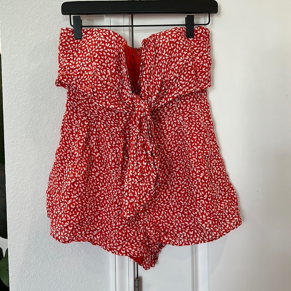 NWT Blue Blush strapless Romper. Size Large. Never worn. Orange red color.